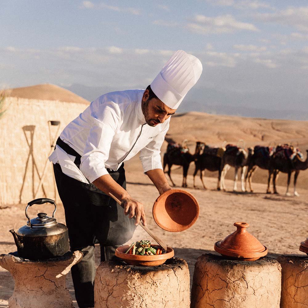 Outdoor cooking activity in the Moroccan desert during an event
