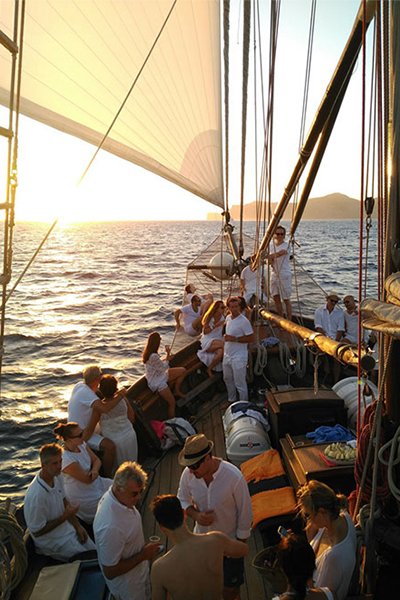 Incentive group enjoying a sailing trip at sunset